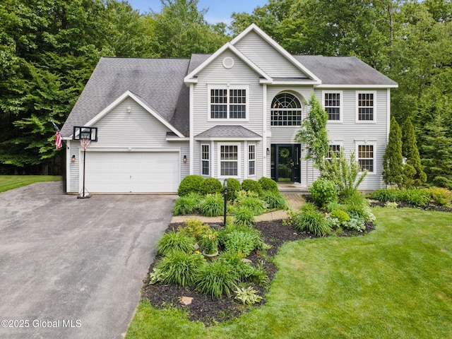 10 Overlook Dr, Wilton, NY 12831 - view of front facade featuring driveway, a shingled roof, a garage, and a front lawn