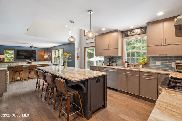 10 Overlook Dr, Wilton, NY 12831 - kitchen with stainless steel dishwasher, tasteful backsplash, wood finished floors, light stone countertops, and recessed lighting