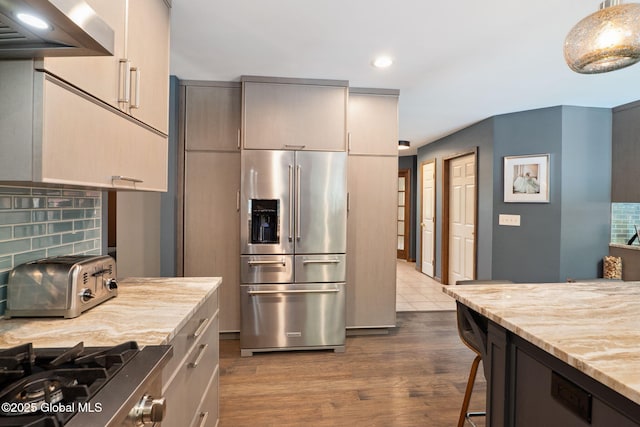 10 Overlook Dr, Wilton, NY 12831 - kitchen featuring appliances with stainless steel finishes, wall chimney exhaust hood, recessed lighting, light stone countertops, and decorative backsplash