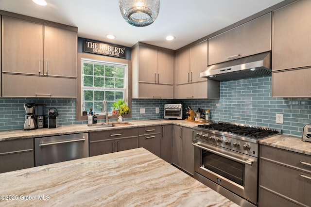 10 Overlook Dr, Wilton, NY 12831 - kitchen with appliances with stainless steel finishes, under cabinet range hood, light stone counters, backsplash, and gray cabinets
