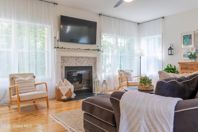 76 Hoffman Ct, Milton, NY 12020 - living room with ceiling fan, a tiled fireplace, and wood finished floors