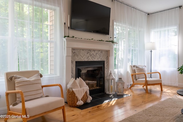 76 Hoffman Ct, Milton, NY 12020 - sitting room with a tile fireplace, plenty of natural light, and wood finished floors
