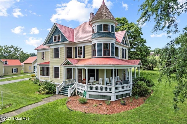 284 Edgemont Rd, Moriah, NY 12960 - victorian-style house featuring covered porch, a chimney, a front lawn, a metal roof, and a standing seam roof