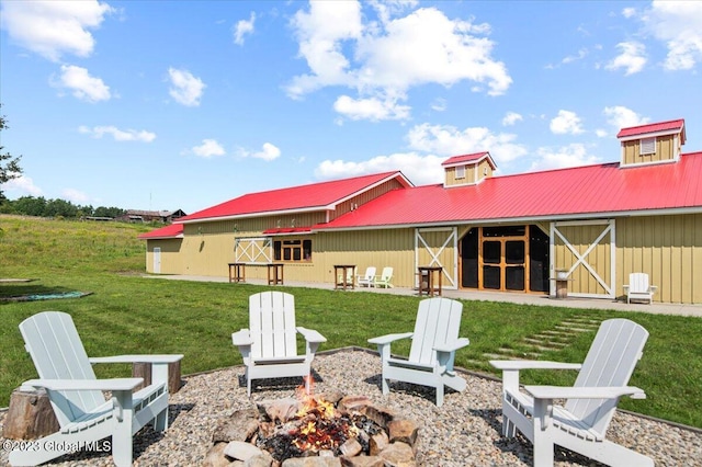 284 Edgemont Rd, Moriah, NY 12960 - rear view of property with an outdoor fire pit, a metal roof, board and batten siding, an outbuilding, and an exterior structure