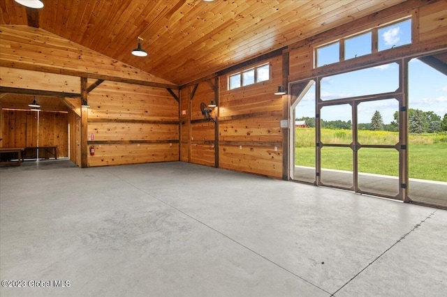 284 Edgemont Rd, Moriah, NY 12960 - unfurnished living room featuring wood walls, finished concrete flooring, high vaulted ceiling, and wood ceiling