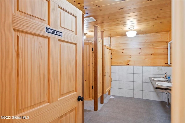 284 Edgemont Rd, Moriah, NY 12960 - bathroom with tile walls, wooden ceiling, tile patterned floors, wood walls, and wainscoting