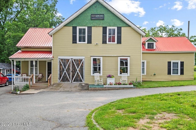 284 Edgemont Rd, Moriah, NY 12960 - view of front facade with covered porch, a metal roof, and a front yard