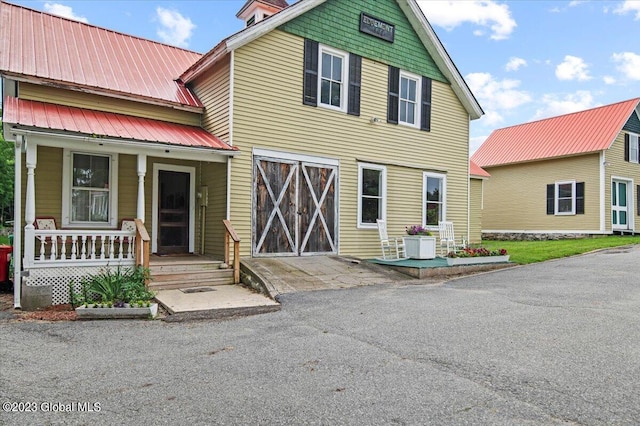 284 Edgemont Rd, Moriah, NY 12960 - view of front of property featuring covered porch and a metal roof