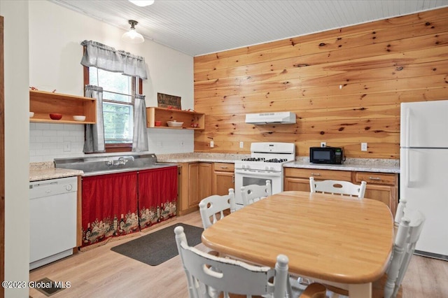 284 Edgemont Rd, Moriah, NY 12960 - kitchen with white appliances, open shelves, under cabinet range hood, light wood finished floors, and wooden walls