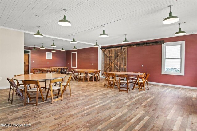 284 Edgemont Rd, Moriah, NY 12960 - dining space featuring wood finished floors, wooden ceiling, and a barn door