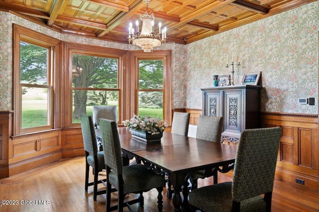 284 Edgemont Rd, Moriah, NY 12960 - dining area featuring plenty of natural light, a chandelier, a wainscoted wall, light wood-style floors, and ornamental molding