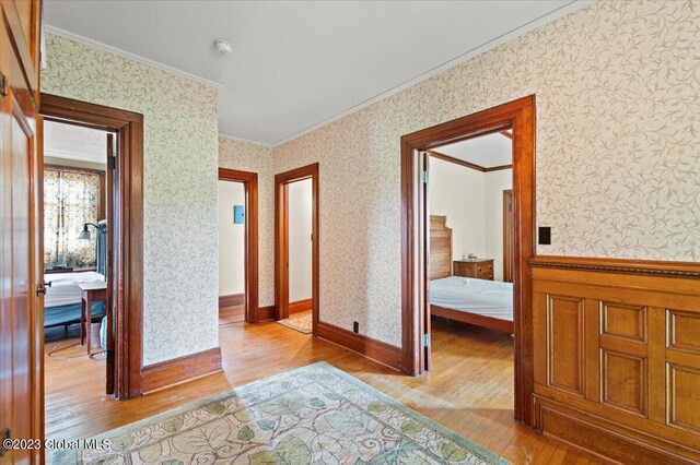 284 Edgemont Rd, Moriah, NY 12960 - hallway with crown molding, wallpapered walls, and hardwood / wood-style flooring