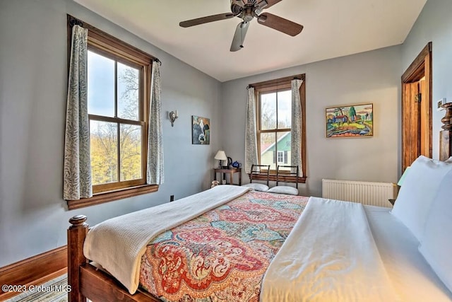 284 Edgemont Rd, Moriah, NY 12960 - bedroom with multiple windows, a ceiling fan, and radiator heating unit