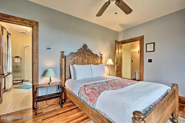 284 Edgemont Rd, Moriah, NY 12960 - bedroom with radiator, light wood-style flooring, and ceiling fan