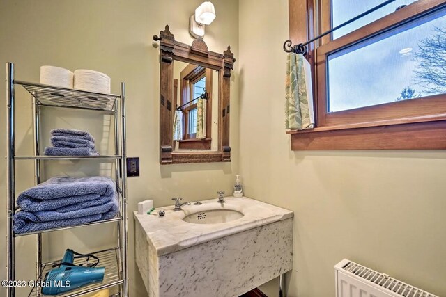 284 Edgemont Rd, Moriah, NY 12960 - bathroom featuring radiator heating unit and vanity