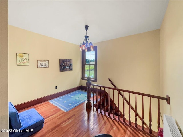 284 Edgemont Rd, Moriah, NY 12960 - stairway with wood finished floors and a chandelier