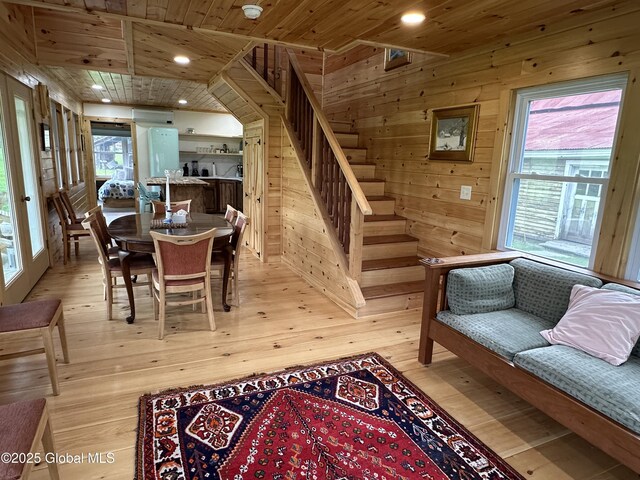 284 Edgemont Rd, Moriah, NY 12960 - dining area featuring light wood-type flooring, wood ceiling, wood walls, recessed lighting, and stairway