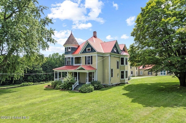 284 Edgemont Rd, Moriah, NY 12960 - view of front facade featuring a porch, a chimney, a front lawn, and a metal roof