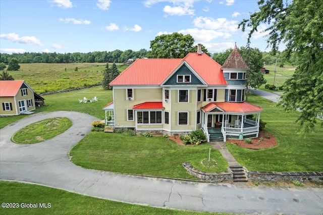 284 Edgemont Rd, Moriah, NY 12960 - victorian house featuring a porch, a front yard, and a metal roof