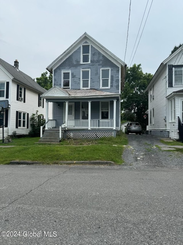 112 Mason St, Johnstown, NY 12095 - traditional style home featuring a porch and a front lawn