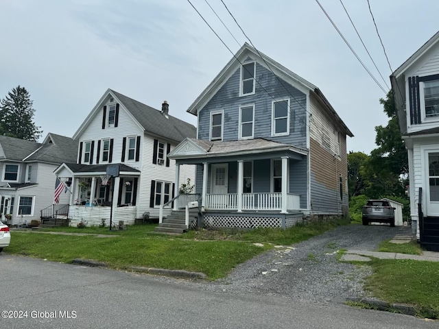 112 Mason St, Johnstown, NY 12095 - traditional style home featuring covered porch and a front lawn