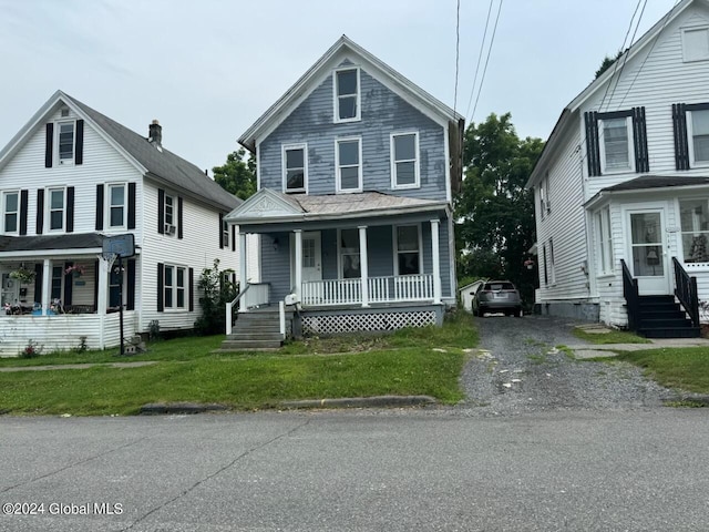 112 Mason St, Johnstown, NY 12095 - traditional style home with a porch, entry steps, and a front yard