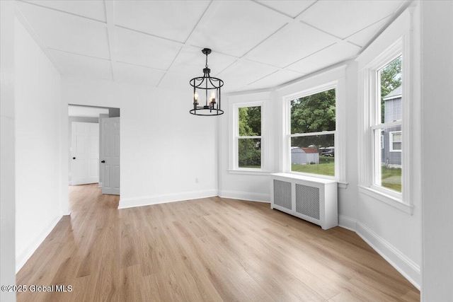 2321 1st Ave, Rotterdam, NY 12303 - unfurnished dining area featuring radiator heating unit, light wood-type flooring, and a chandelier