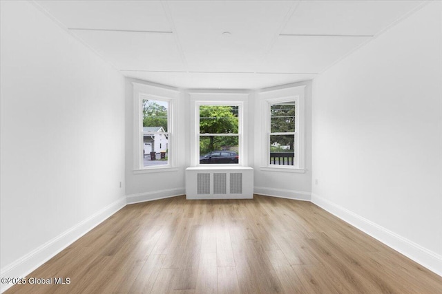 2321 1st Ave, Rotterdam, NY 12303 - unfurnished living room featuring wood finished floors, plenty of natural light, and radiator heating unit