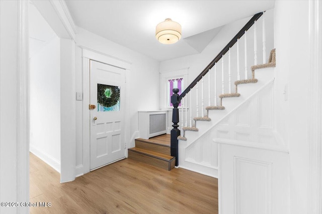 2321 1st Ave, Rotterdam, NY 12303 - foyer featuring wood finished floors, stairway, and radiator heating unit
