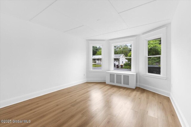 2321 1st Ave, Rotterdam, NY 12303 - unfurnished living room featuring radiator and light wood-style flooring