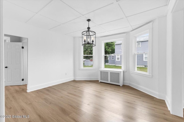 2321 1st Ave, Rotterdam, NY 12303 - unfurnished dining area featuring radiator heating unit, a chandelier, and light wood finished floors