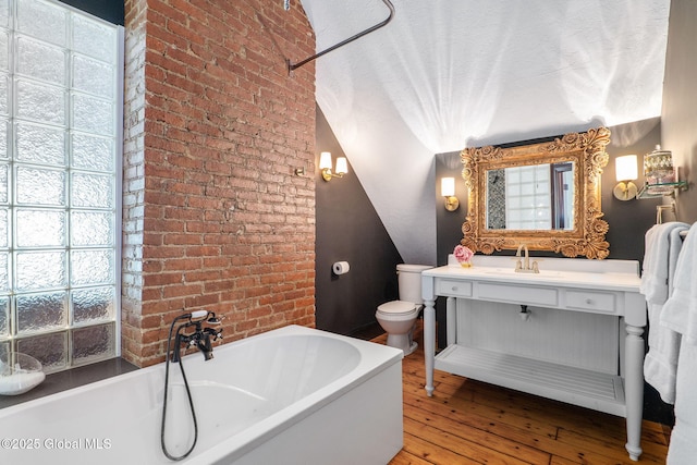 462-470 2nd Ave, Troy, NY 12182 - full bath with a garden tub, hardwood / wood-style flooring, brick wall, and vanity