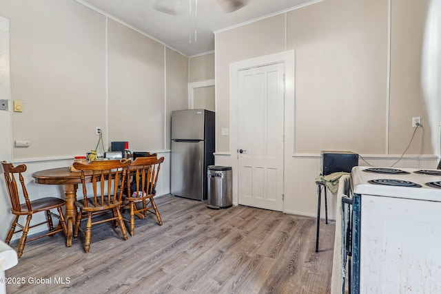 462-470 2nd Ave, Troy, NY 12182 - kitchen with freestanding refrigerator, white range with electric cooktop, wood finished floors, crown molding, and wainscoting