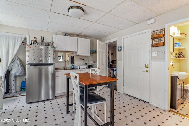 462-470 2nd Ave, Troy, NY 12182 - kitchen with freestanding refrigerator, light floors, a paneled ceiling, white cabinetry, and light countertops