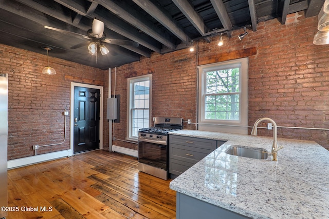 462-470 2nd Ave, Troy, NY 12182 - kitchen with stainless steel range with gas stovetop, gray cabinets, light stone counters, hardwood / wood-style floors, and brick wall