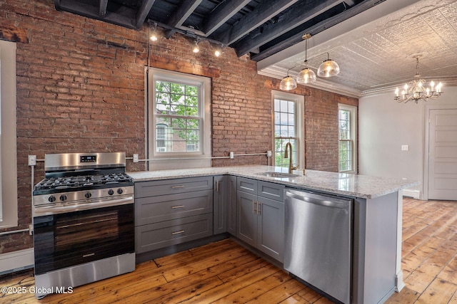 462-470 2nd Ave, Troy, NY 12182 - kitchen with appliances with stainless steel finishes, gray cabinets, light wood finished floors, brick wall, and light stone counters