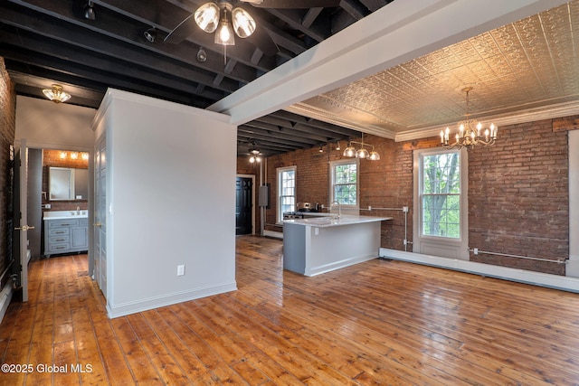 462-470 2nd Ave, Troy, NY 12182 - kitchen with a chandelier, wood-type flooring, brick wall, baseboard heating, and light countertops