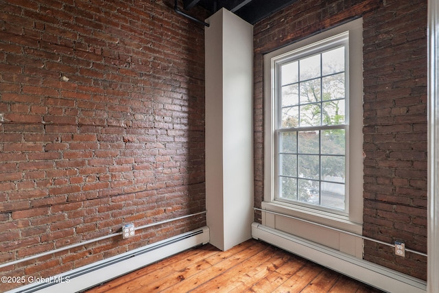 462-470 2nd Ave, Troy, NY 12182 - unfurnished room featuring a baseboard heating unit, a baseboard radiator, brick wall, and hardwood / wood-style floors