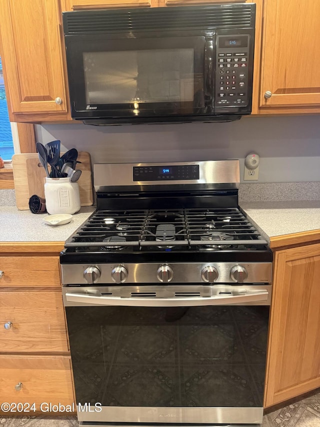 31 Wilson Ave, South Glens Falls, NY 12803 - kitchen view of stainless steel gas stove, black microwave, and light countertops