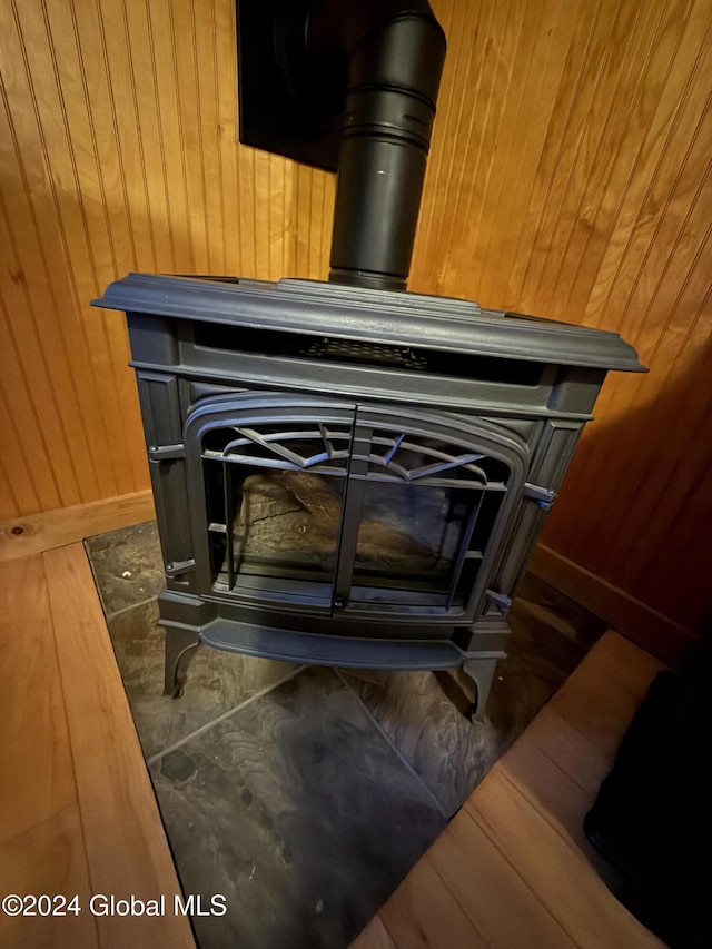 31 Wilson Ave, South Glens Falls, NY 12803 - detailed view of a wood stove, wooden walls, and wood finished floors