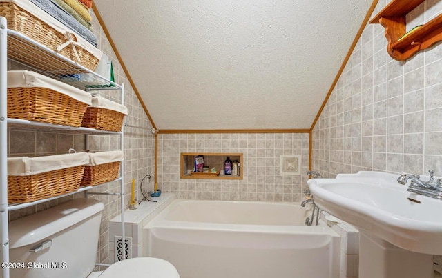 31 Wilson Ave, South Glens Falls, NY 12803 - full bath featuring tile walls, lofted ceiling, a garden tub, and a textured ceiling