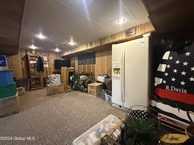 31 Wilson Ave, South Glens Falls, NY 12803 - finished below grade area featuring white refrigerator with ice dispenser, a paneled ceiling, wooden walls, and carpet floors