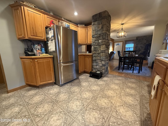 31 Wilson Ave, South Glens Falls, NY 12803 - kitchen with decorative columns, freestanding refrigerator, and brown cabinetry