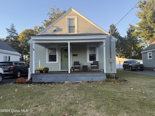 31 Wilson Ave, South Glens Falls, NY 12803 - view of front of property with covered porch and a front yard