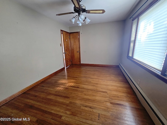 1335 Midline Rd, Amsterdam, NY 12010 - unfurnished room with a baseboard radiator, wood finished floors, and a ceiling fan