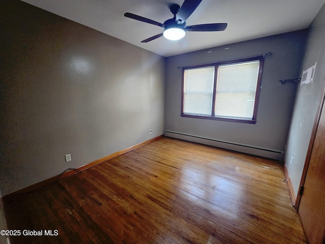 1335 Midline Rd, Amsterdam, NY 12010 - unfurnished room featuring a baseboard heating unit, a ceiling fan, and wood finished floors