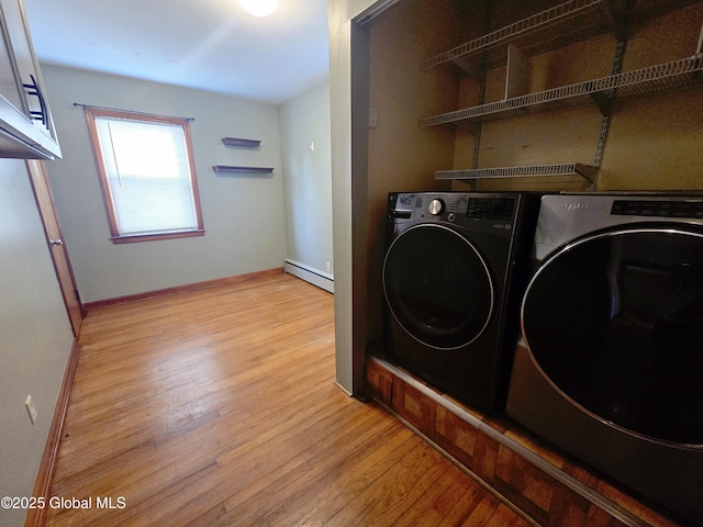 1335 Midline Rd, Amsterdam, NY 12010 - washroom with a baseboard radiator, light wood finished floors, separate washer and dryer, and cabinet space