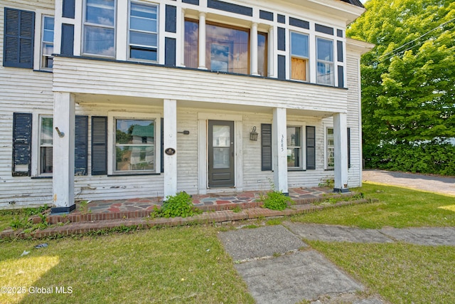 3885 Main St, Warrensburg, NY 12885 - view of property featuring covered porch and a front yard