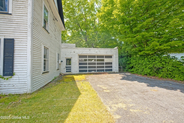 3885 Main St, Warrensburg, NY 12885 - view of yard featuring driveway and a garage