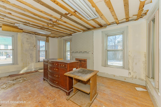 3885 Main St, Warrensburg, NY 12885 - kitchen featuring healthy amount of natural light, a brick fireplace, and a kitchen island